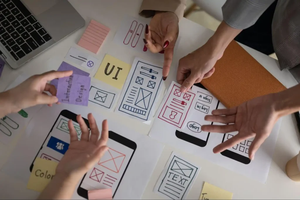 image with hands pointing at ux - how to build ux design portfolio